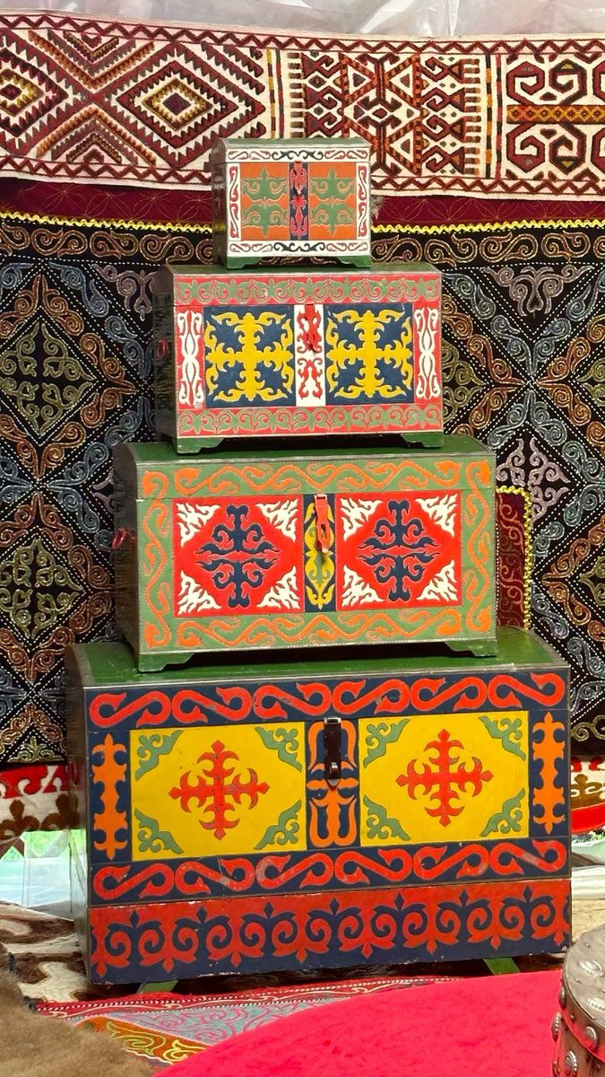 Stacked wooden chests painted with bright traditional Kazakh patterns