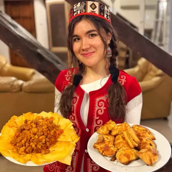 Plates of plov and baursak — traditional Central Asian food on a home table