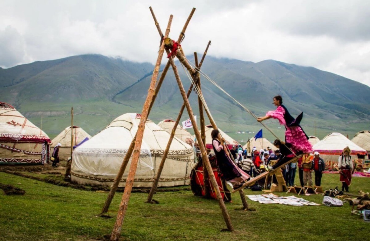 Yurts and a traditional swing at an ethno village in Kazakhstan