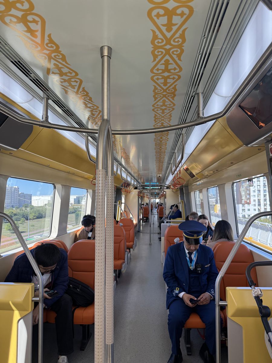 Inside a modern train with golden ornament patterns on the ceiling